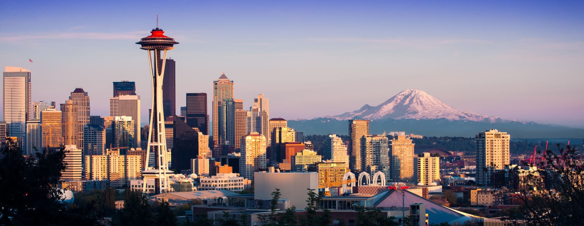 Experience Iconic Seattle; photo of skyline of Seattle with Mt Rainier in the background.